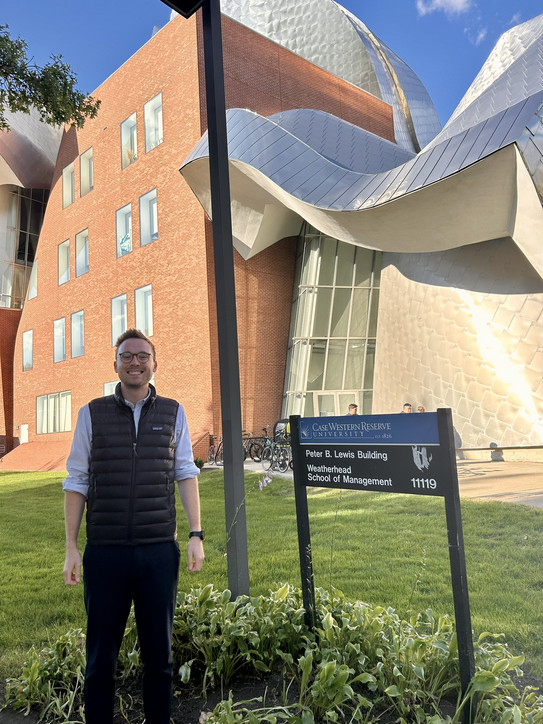 Vincent Heimburg standing before a building of Case Western Reserve University