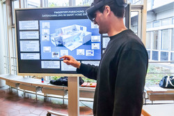 Person with VR glasses in front of smart home poster