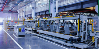 A production line with several machines lined up in a row in a modern factory.