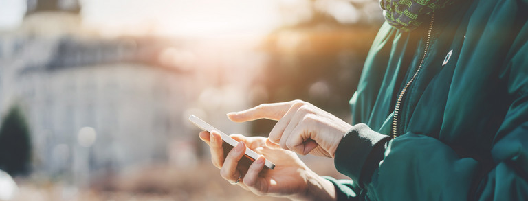  A person types in something on a smartphone