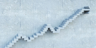 Career steps Stepped stairs protrude from a gray wall.