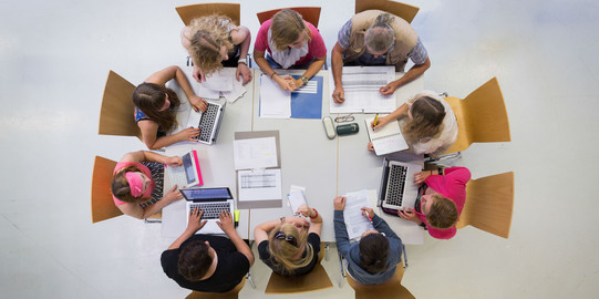 People sitting in a circle talking shot from above.